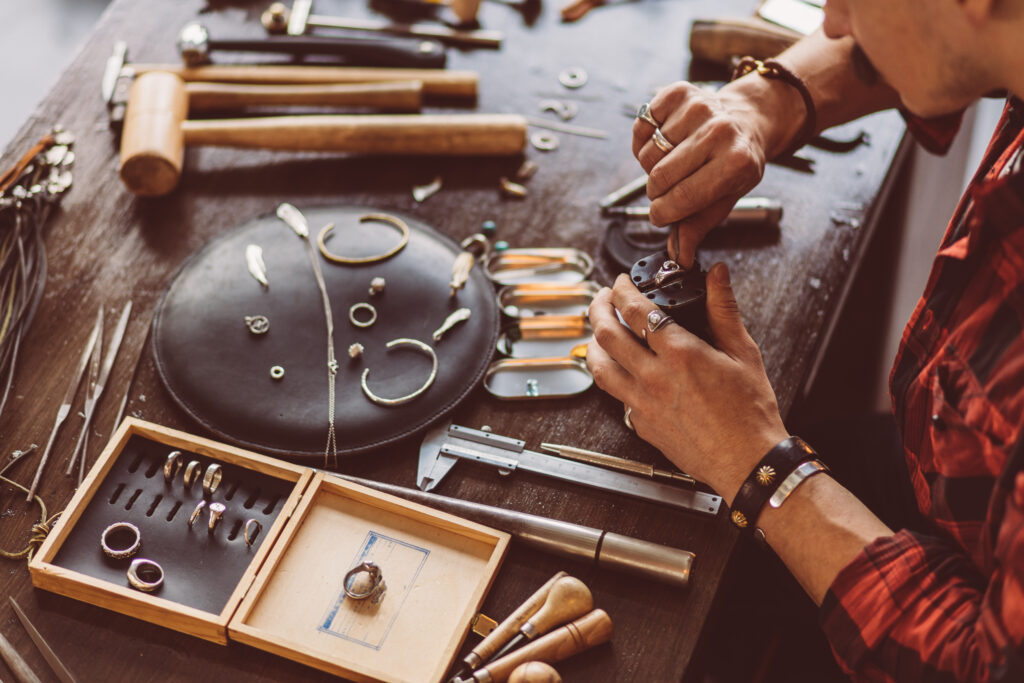 man cleaning the jewellery for client